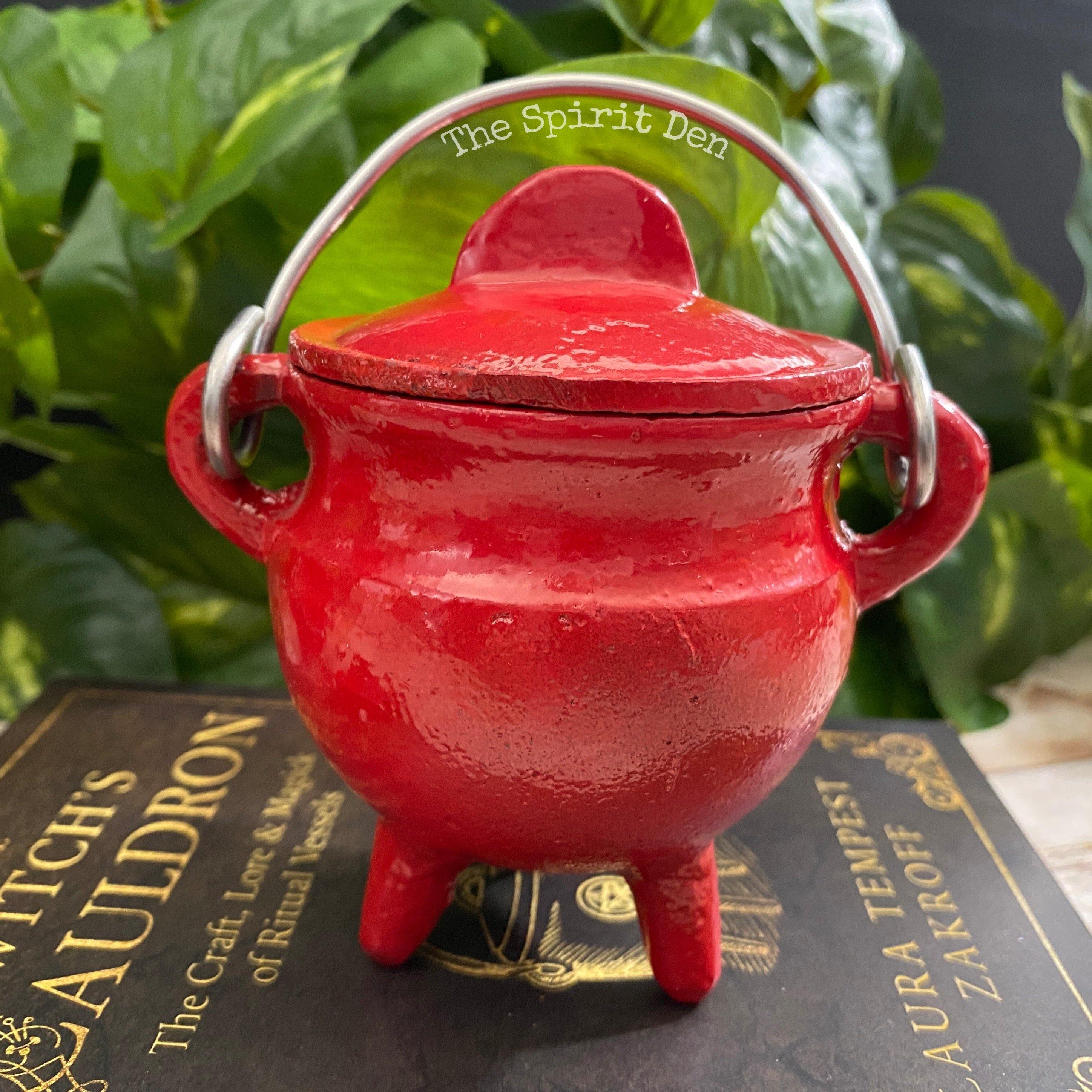 red enameled small cast iron cauldron